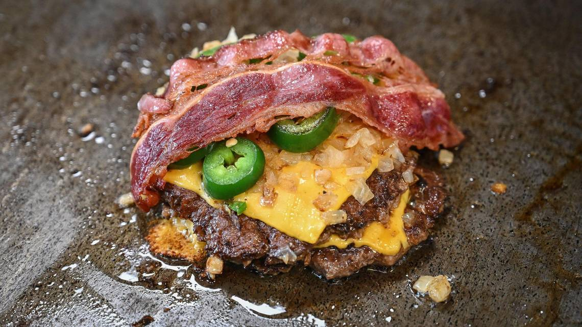 “The Main,” Main Street Burgers’ signature burger, features two smash burger patties, cheese, grilled onions and jalapeños and bacon. CRAIG KOHLRUSS ckohlruss@fresnobee.com